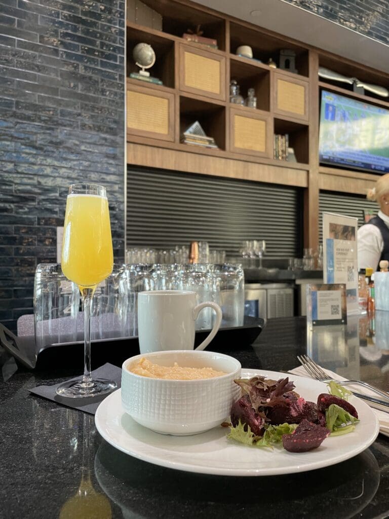 a plate of food and a glass of orange juice on a counter