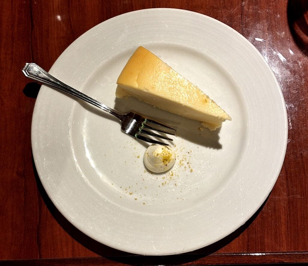 a slice of cheesecake on a plate with a fork