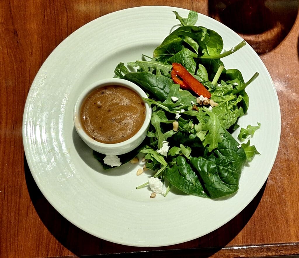 a plate of salad with sauce