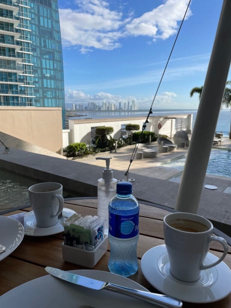 a table with a drink and a bottle of water on it