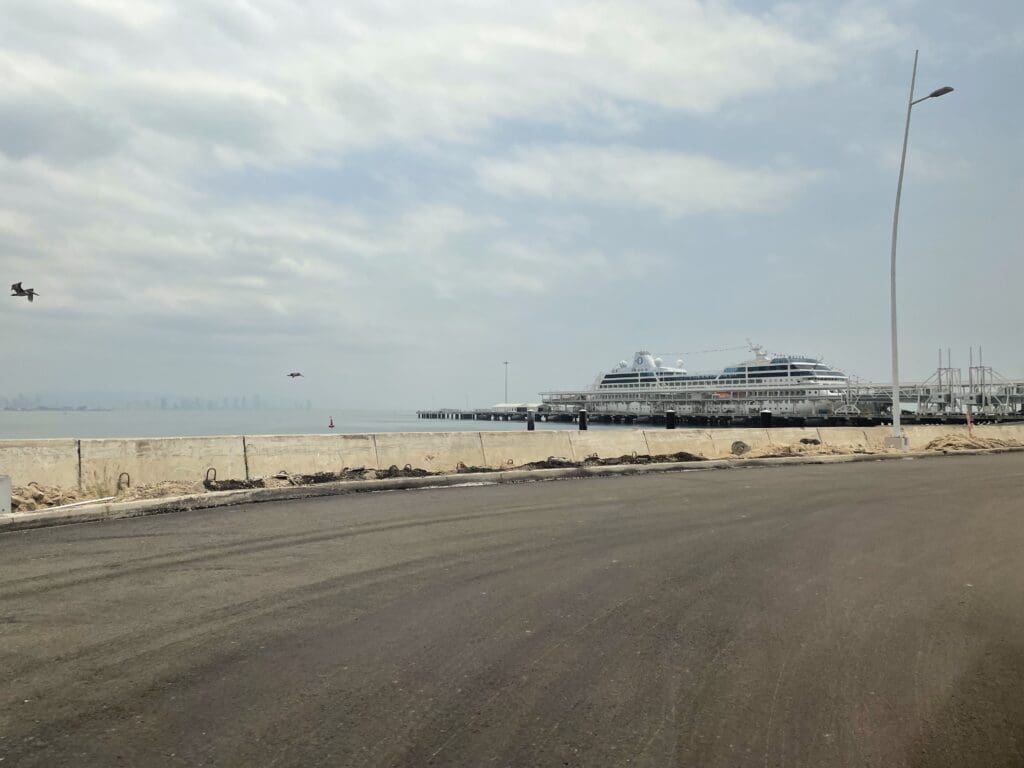 a road with a large ship in the distance