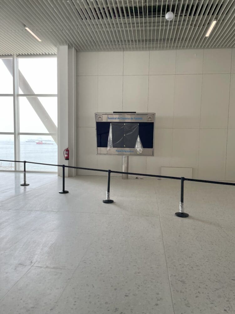 a white room with a black railing and a screen