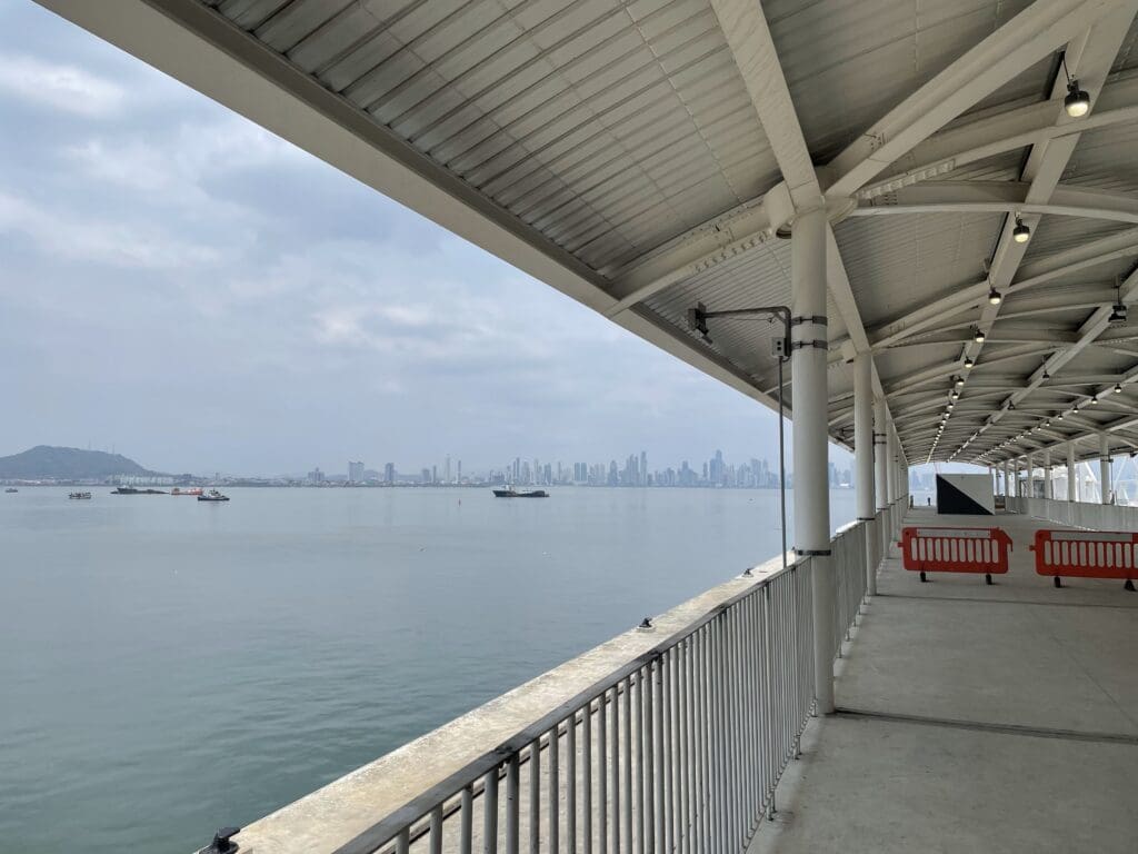 a covered walkway overlooking a body of water