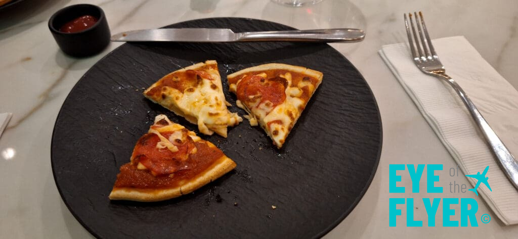 a plate with pizza and a knife