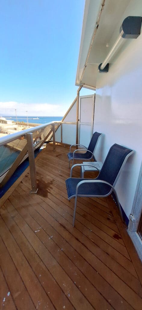 chairs on a deck overlooking the ocean