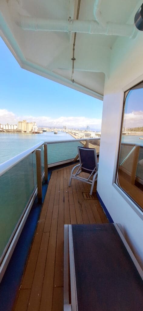 a deck with a chair on a boat