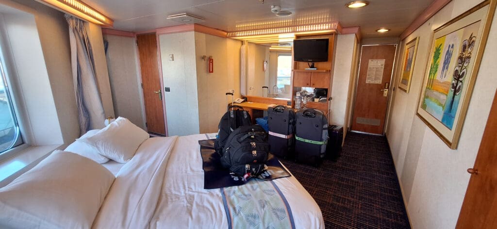 a room with a bed and luggage