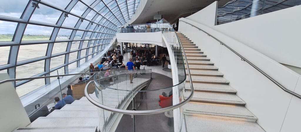 a large glass staircase with people sitting on it