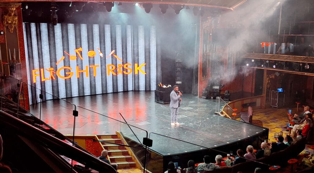 a man on a stage with smoke and lights