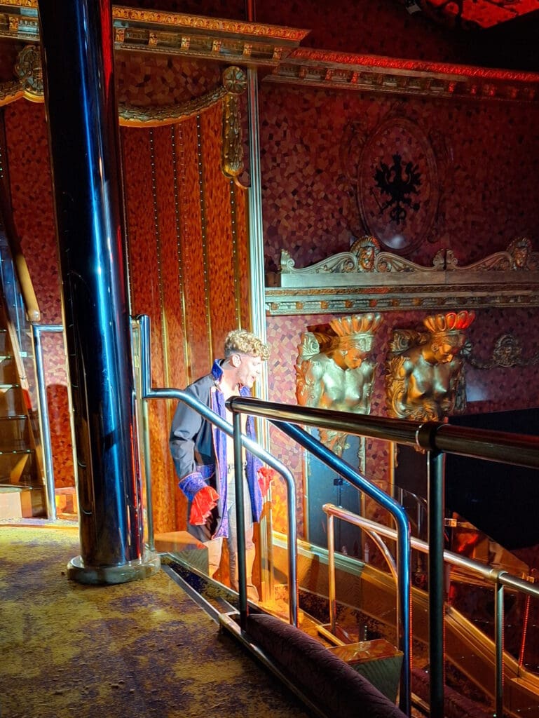 a man standing in a room with a railing