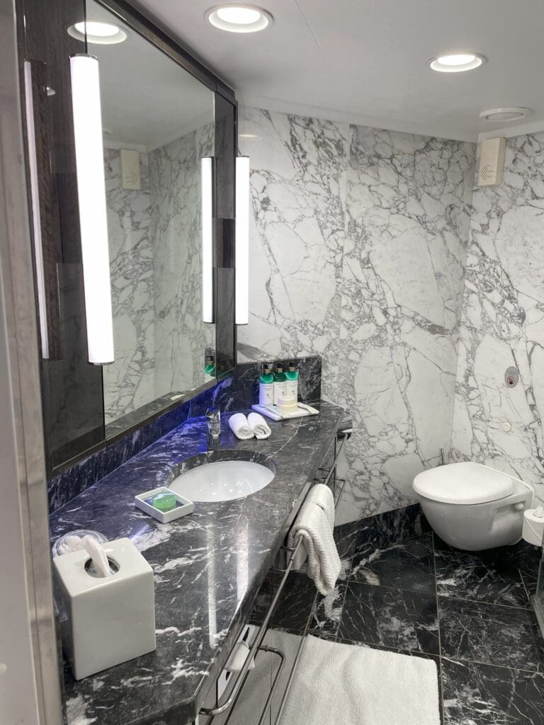 a bathroom with marble countertop and a toilet