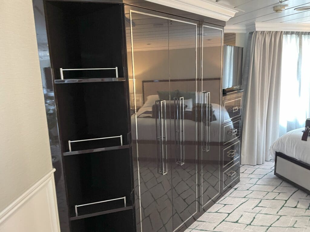 a black and silver closet with a mirror on the side