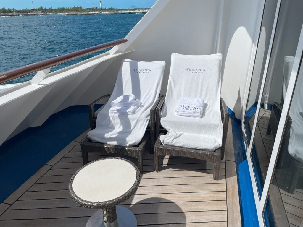 chairs on a boat with water in the background