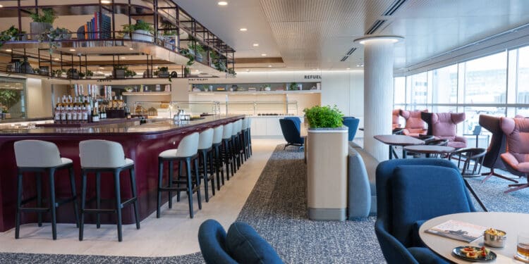 The bar and some seating areas are sene at the Capital One Lounge inside Denver International Airport (DEN).