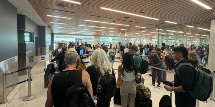 Passengers wait for another scan after initially being cleared in the CLEAR line at Denver International Airport (DEN)