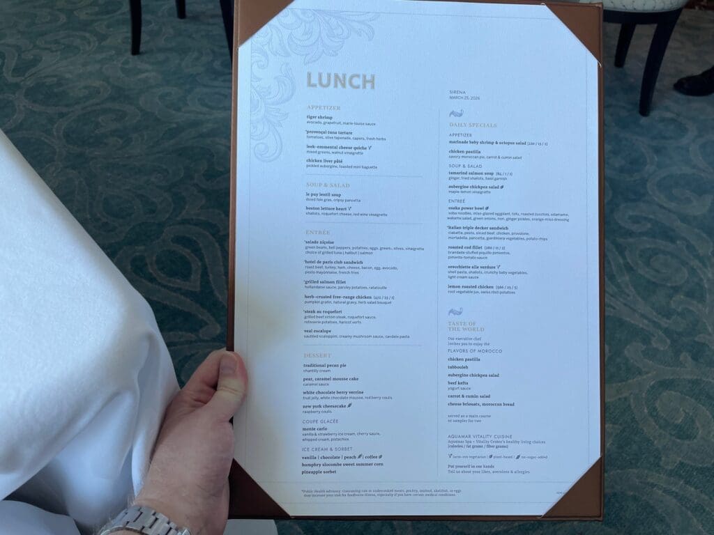 a hand holding a menu