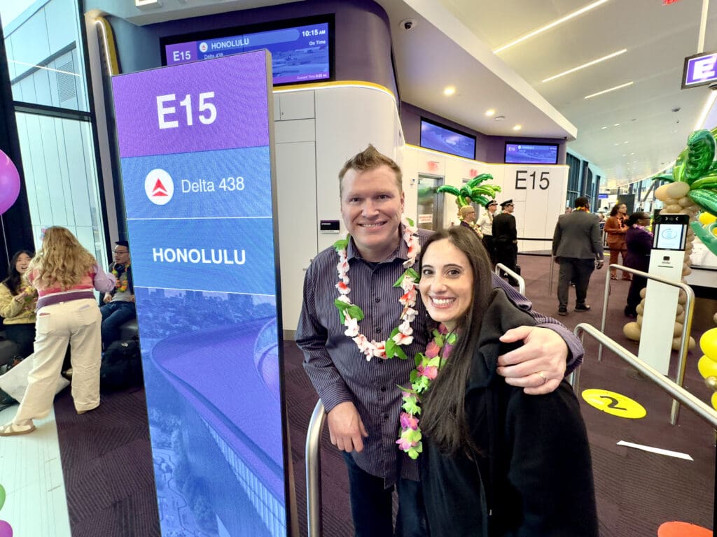 Eye of the Flyer blogger Chris Carley and his wife pose for a picture during Delta Air Lines’ inaugural flight from Boston (BOS) to Honolulu (HNL) at Boston Logan International Airport on Thursday, November 21, 2024. (©LK Photography, special to Eye of the Flyer)