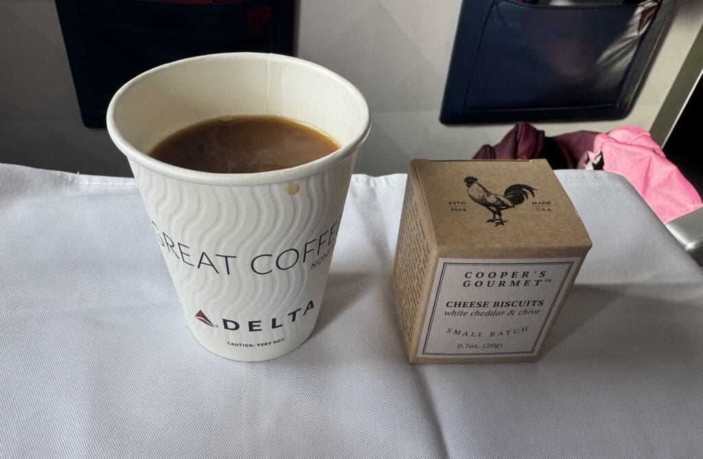 Coffee and Cooper's Gourmet Cheddar Biscuits served in Delta Premium Select.