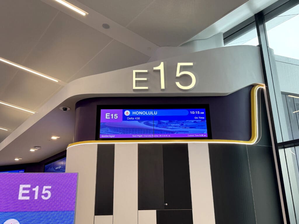 An electronic sign displaying Delta Air Lines flight 438 to Honolulu, departing from gate E15, is seen during the party for Delta Air Lines’ inaugural flight from Boston (BOS) to Honolulu (HNL) at Boston Logan International Airport on Thursday, November 21, 2024. ©EyeOfTheFlyer.com