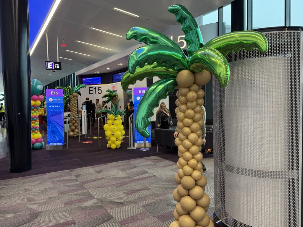 A balloon palm tree and balloon pineapple are seen during the party for Delta Air Lines’ inaugural flight from Boston (BOS) to Honolulu (HNL) at Boston Logan International Airport on Thursday, November 21, 2024. (©Eye of the Flyer)