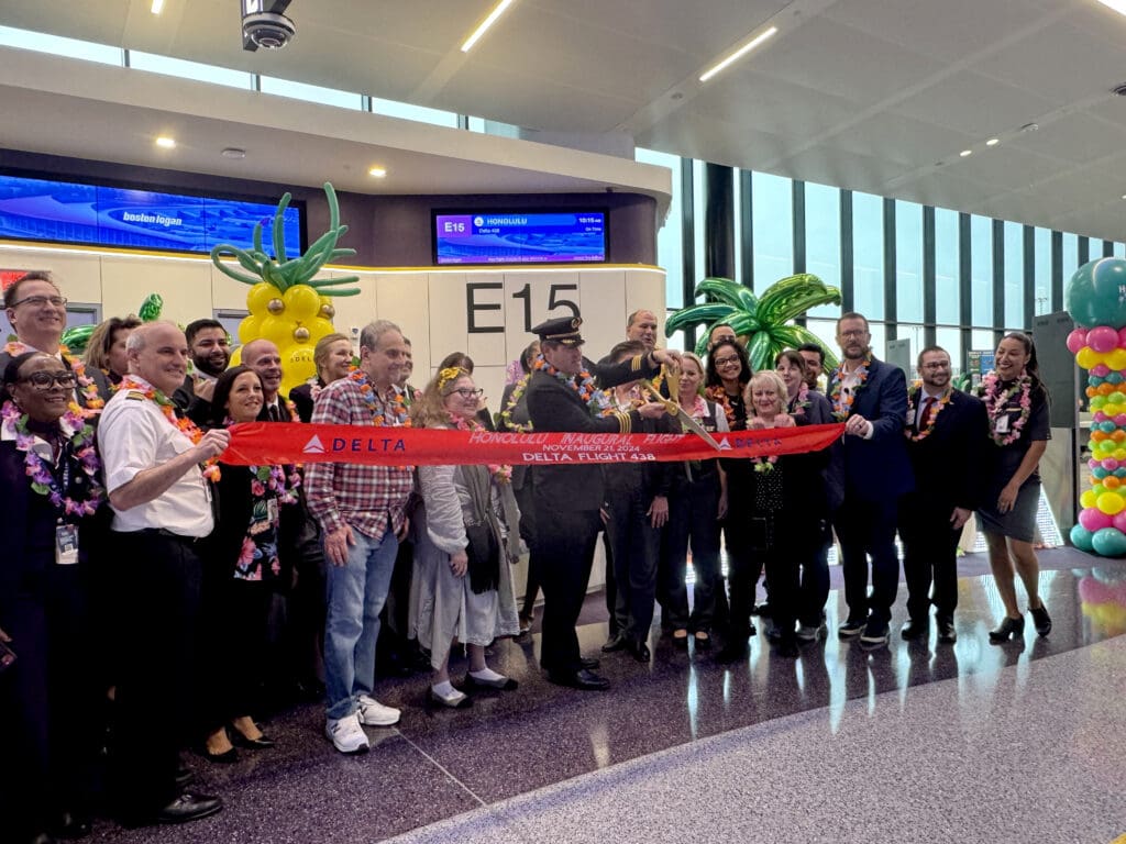 Delta Air Lines crew, representatives, and Million Milers cut a celebratory ribbon during the party for Delta Air Lines’ inaugural flight from Boston (BOS) to Honolulu (HNL) at Boston Logan International Airport on Thursday, November 21, 2024. (©Eye of the Flyer)