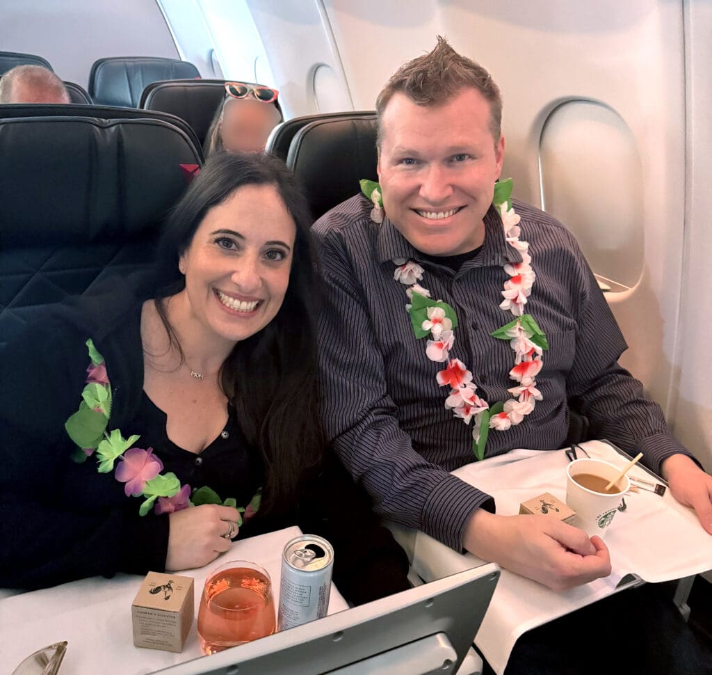 Eye of the Flyer blogger Chris Carley and his wife aboard Delta Air Lines' inaugural Boston (BOS) to Honolulu (HNL) flight. They sat in row 20, seats A and B. (Photo credit: Sherry Martin Peters)