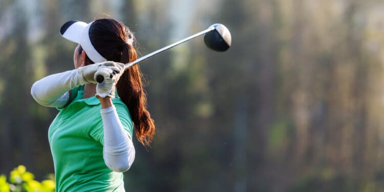 Golfer sport course golf ball fairway. People lifestyle woman playing game golf tee off on the green grass. Asia female player game shot in summer. Healthy and Sport outdoor