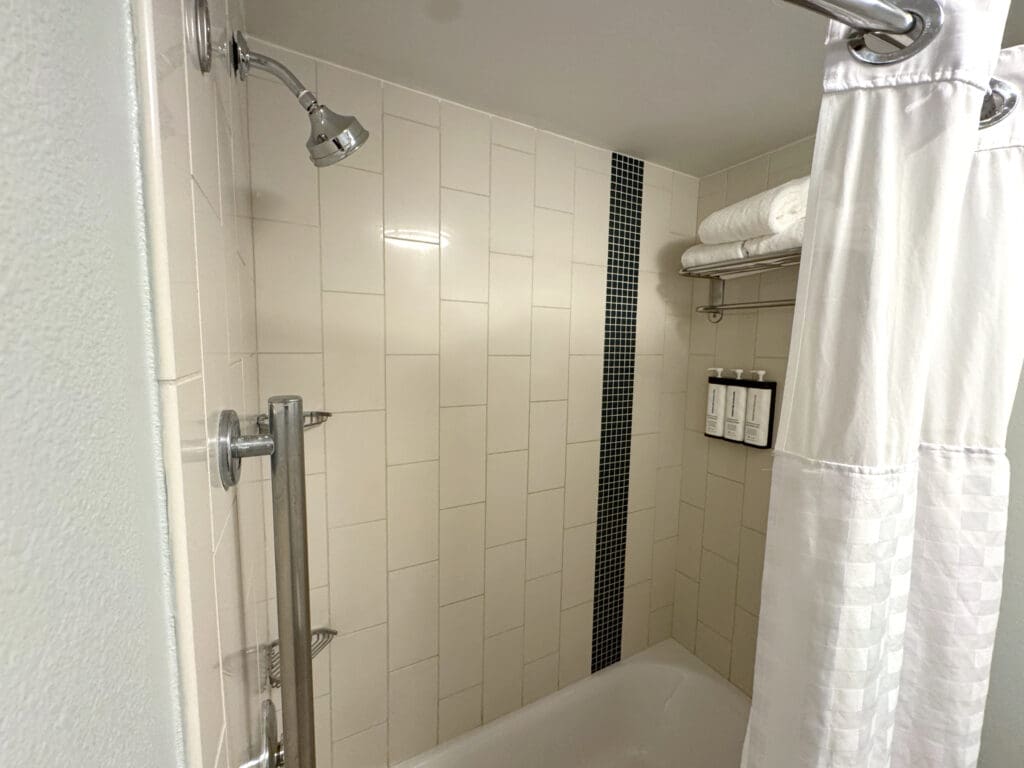 Tub, shower, towels, and toiletries at Hyatt Place Waikiki