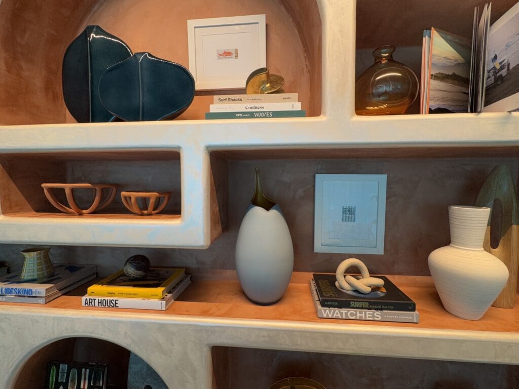 Books related to surfing are displayed inside Chase Sapphire Lounge by The Club at the San Diego International Airport (SAN)