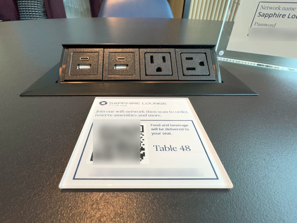 A table and power outlet inside the Chase Sapphire Lounge by The Club at the San Diego International Airport (SAN)