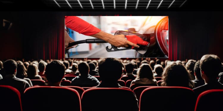 a person holding a gas pump in a movie theater