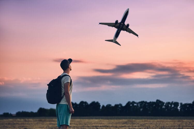 A man watches a Delta Air Lines plane depart.