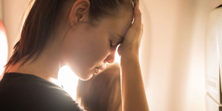 A nervous, worried, anxious female airline passenger.