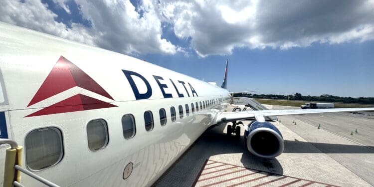 A Delta Air Lines Boeing 737-900ER is seen at Owen Roberts International Airport on Grand Cayman (GCM).