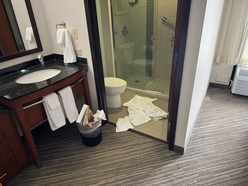 An unmade hotel bathroom