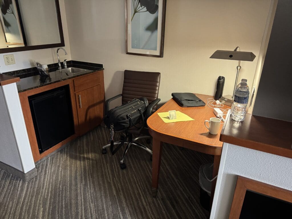A desk and chair in a hotel room