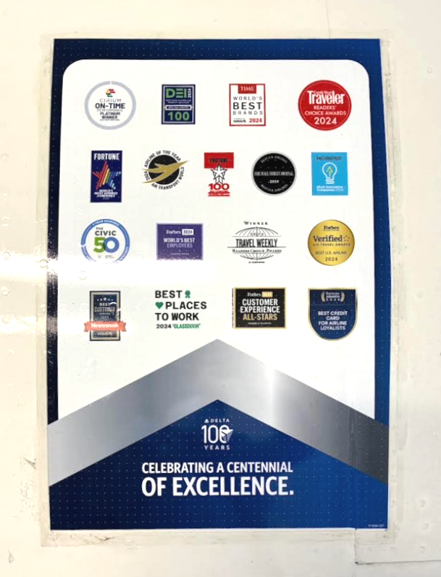The image is a poster featuring various award logos and badges. These include accolades for on-time performance, best brands, readers' choice awards, and customer experience, among others. The bottom section of the poster has a blue and silver design with the text "Celebrating a Centennial of Excellence" and a logo indicating 100 years.