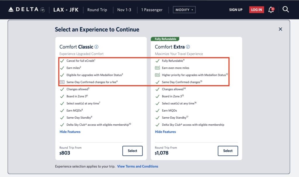 The image is a screenshot of a Delta Airlines booking page for a round trip from LAX to JFK. It presents two options for selecting a travel experience: "Comfort Classic" and "Comfort Extra." - "Comfort Classic" includes features like canceling for full eCredit, earning miles, eligibility for upgrades with Medallion Status, and same-day confirmed changes for a fee. The price is $803. - "Comfort Extra" is fully refundable, offers more miles, higher priority for upgrades, and same-day confirmed changes. The price is $1,078. Both options list additional features like changes allowed, boarding zone, seat selection, earning MQDs, same-day standby, and Delta Sky Club access with eligible membership. There are buttons to select each option.
