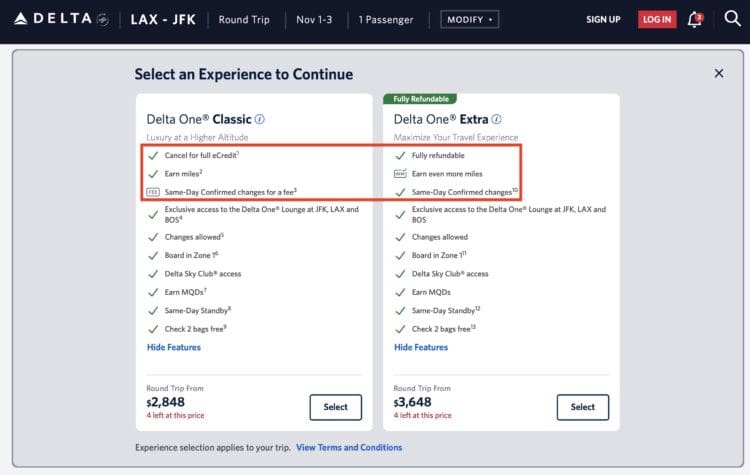 The image is a screenshot of a flight booking page from Delta, showing two options for a round trip from LAX to JFK. The options are "Delta One Classic" and "Delta One Extra." Each option lists features such as cancellation policies, earning miles, lounge access, and baggage allowances. The "Delta One Classic" option is priced at $2,848, while the "Delta One Extra" is priced at $3,648. Both options have a "Select" button, and certain features are highlighted with checkmarks or a "FEE" label.