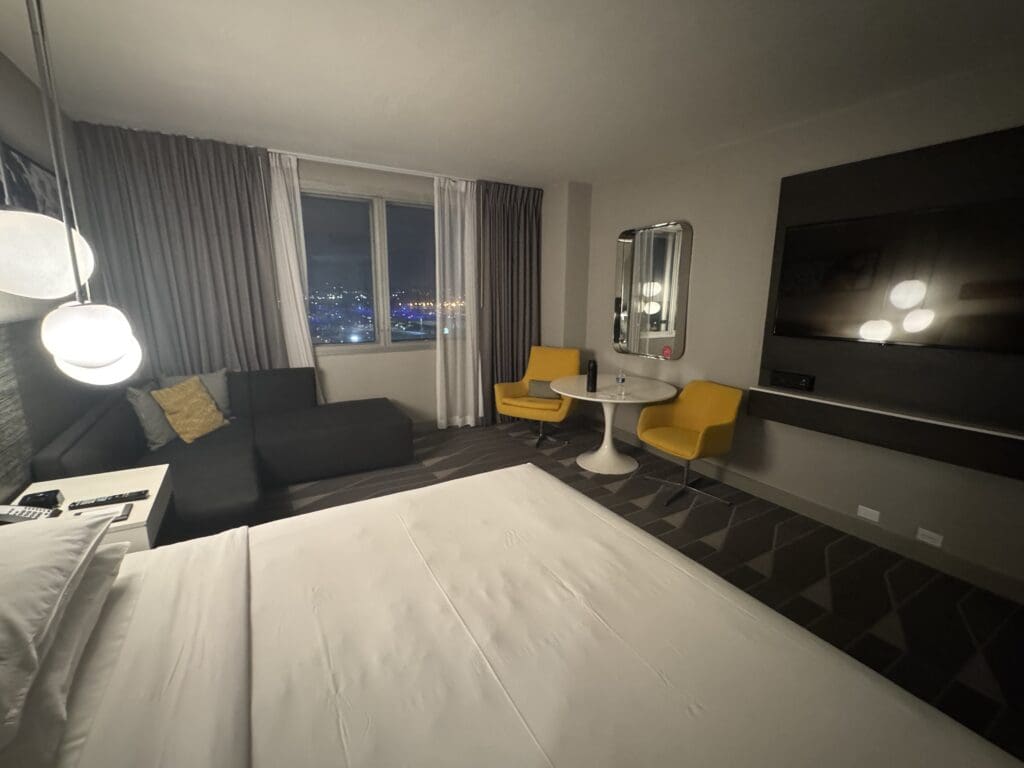 a room with a bed and a television