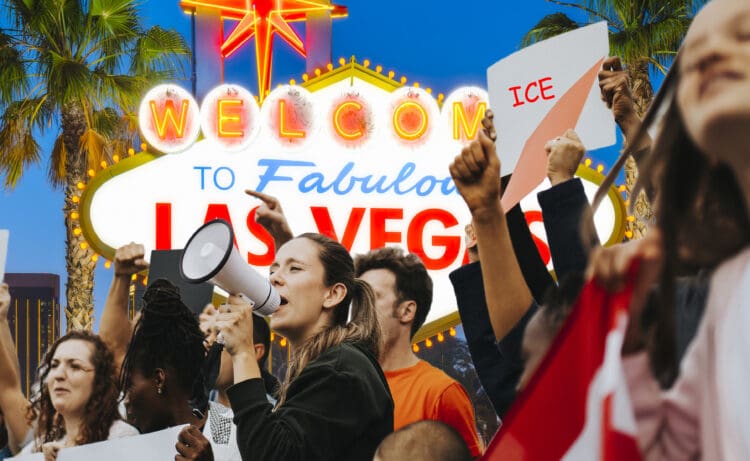 A group of people is gathered in front of the iconic "Welcome to Fabulous Las Vegas" sign. One person is speaking into a megaphone, while others hold up signs, one of which reads "ICE." The scene suggests a protest or demonstration, with palm trees and the bright lights of Las Vegas in the background.