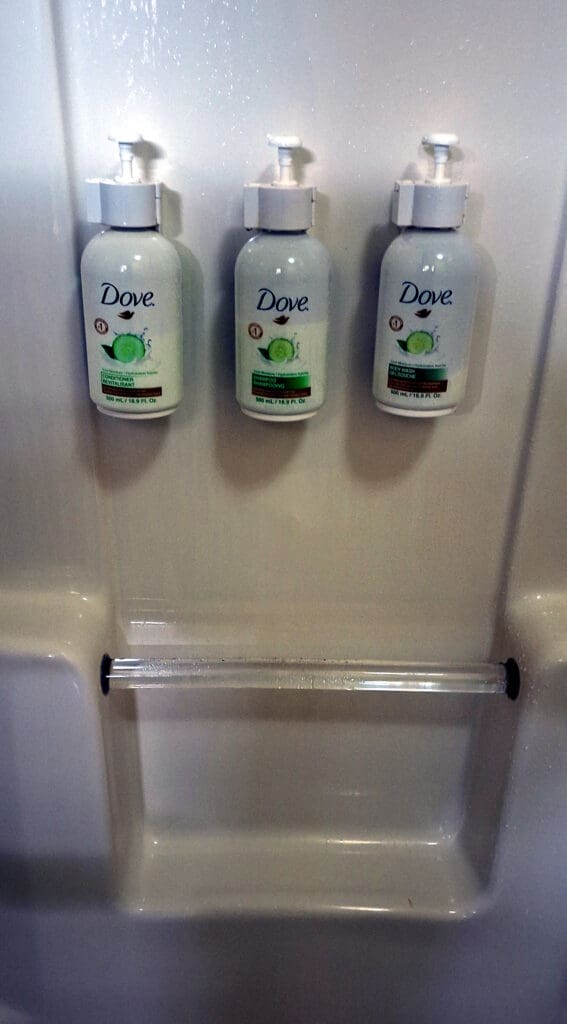 a group of white bottles with green labels on them