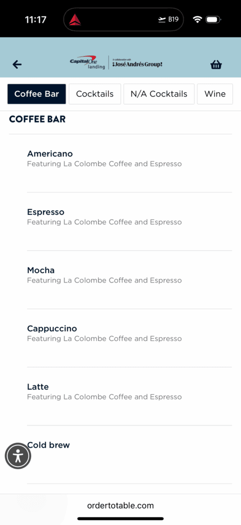 The image shows a digital menu from a coffee bar. It lists various coffee options, each featuring La Colombe Coffee and Espresso. The options include: - Americano - Espresso - Mocha - Cappuccino - Latte - Cold Brew The menu is part of a collaboration with José Andrés Group and is accessible via ordertotable.com. The top of the image shows a navigation bar with options for Coffee Bar, Cocktails, N/A Cocktails, and Wine.