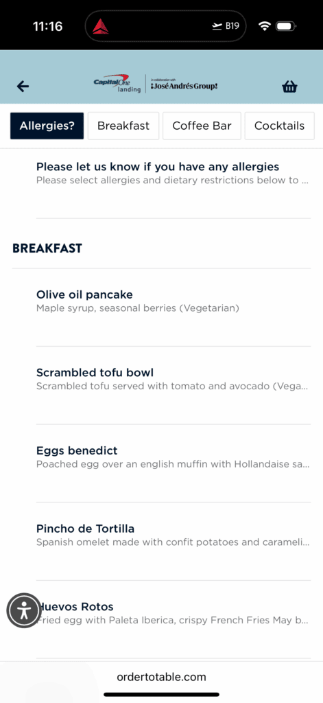 The image shows a digital menu interface from a collaboration between Capital One Landing and José Andrés Group. It includes tabs for "Allergies?", "Breakfast", "Coffee Bar", and "Cocktails". The breakfast menu lists items such as: - Olive oil pancake with maple syrup and seasonal berries (Vegetarian) - Scrambled tofu bowl with tomato and avocado (Vegan) - Eggs benedict with a poached egg over an English muffin and Hollandaise sauce - Pincho de Tortilla, a Spanish omelet with confit potatoes and caramelized onions - Huevos Rotos, a fried egg with Paleta Iberica and crispy French fries The top of the screen shows the time as 11:16 and a flight icon with "B19". The bottom of the screen displays "ordertotable.com".