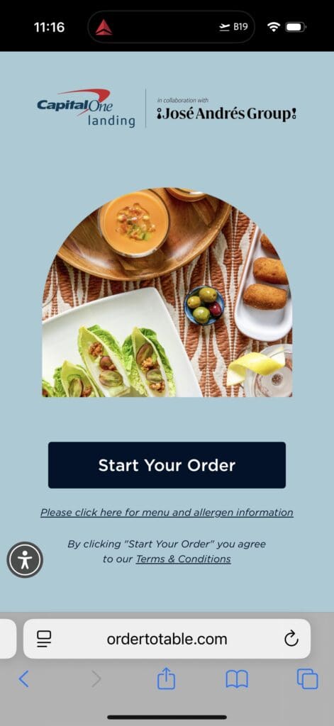The image is a screenshot of a mobile webpage for "Capital One Landing in collaboration with José Andrés Group." It features a photo of a meal with a bowl of soup, lettuce wraps with grapes and nuts, a small dish of olives, and croquettes on a patterned tablecloth. Below the image, there is a button labeled "Start Your Order" and links for menu and allergen information, as well as terms and conditions. The URL at the bottom is "ordertotable.com."