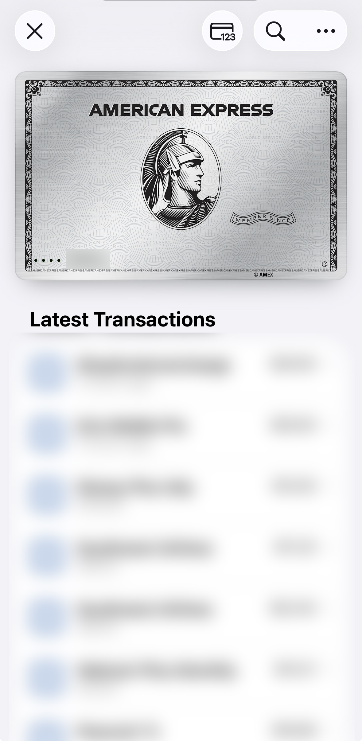 The image shows a digital representation of an American Express card at the top, featuring the company's logo and a classical warrior profile. Below the card, there is a blurred list titled "Latest Transactions," indicating recent financial activities, with amounts and details obscured. The interface includes icons for closing, viewing, and searching at the top.