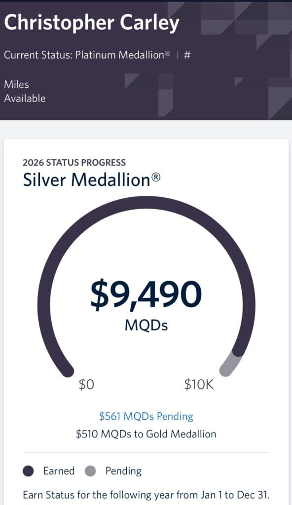 The image is a screenshot of a loyalty program status page for a person named Christopher Carley. It shows the current status as "Platinum Medallion®" and the 2026 status progress towards "Silver Medallion®." The progress bar indicates $9,490 MQDs earned, with a goal of $10,000. There are $561 MQDs pending, and $510 MQDs are needed to reach Gold Medallion® status. A legend shows dark circles for "Earned" and light circles for "Pending." The note at the bottom states that status is earned for the following year from January 1 to December 31.