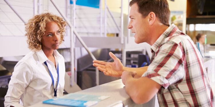Angry Passenger Complaining To Staff At Airport Check In