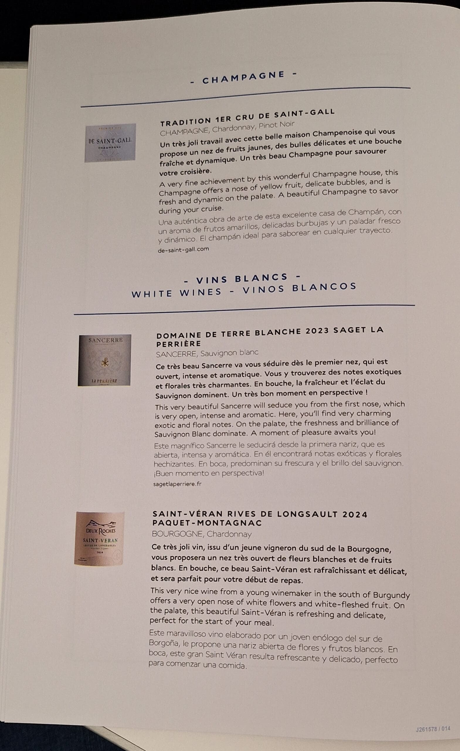 The image shows a page from a wine menu or catalog. It is divided into sections for "Champagne" and "White Wines" (also listed in French and Spanish). Each section includes descriptions of different wines:

1. **Champagne:**
   - **Tradition 1er Cru de Saint-Gall:** Described as having a nose of yellow fruit, delicate bubbles, and a fresh, dynamic palate. The description is provided in French, English, and Spanish.

2. **White Wines:**
   - **Domaine de Terre Blanche 2023 Saget La Perrière:** A Sancerre wine with a description highlighting its open, intense, and aromatic qualities, with exotic and floral notes. The description is in French, English, and Spanish.
   - **Saint-Véran Rives de Longsault 2024 Paquet-Montagnac:** A Burgundy Chardonnay described as having a nose of white flowers and white-fleshed fruit, with a refreshing and delicate palate. The description is in French, English, and Spanish.

Each wine entry includes a small image of the wine label.