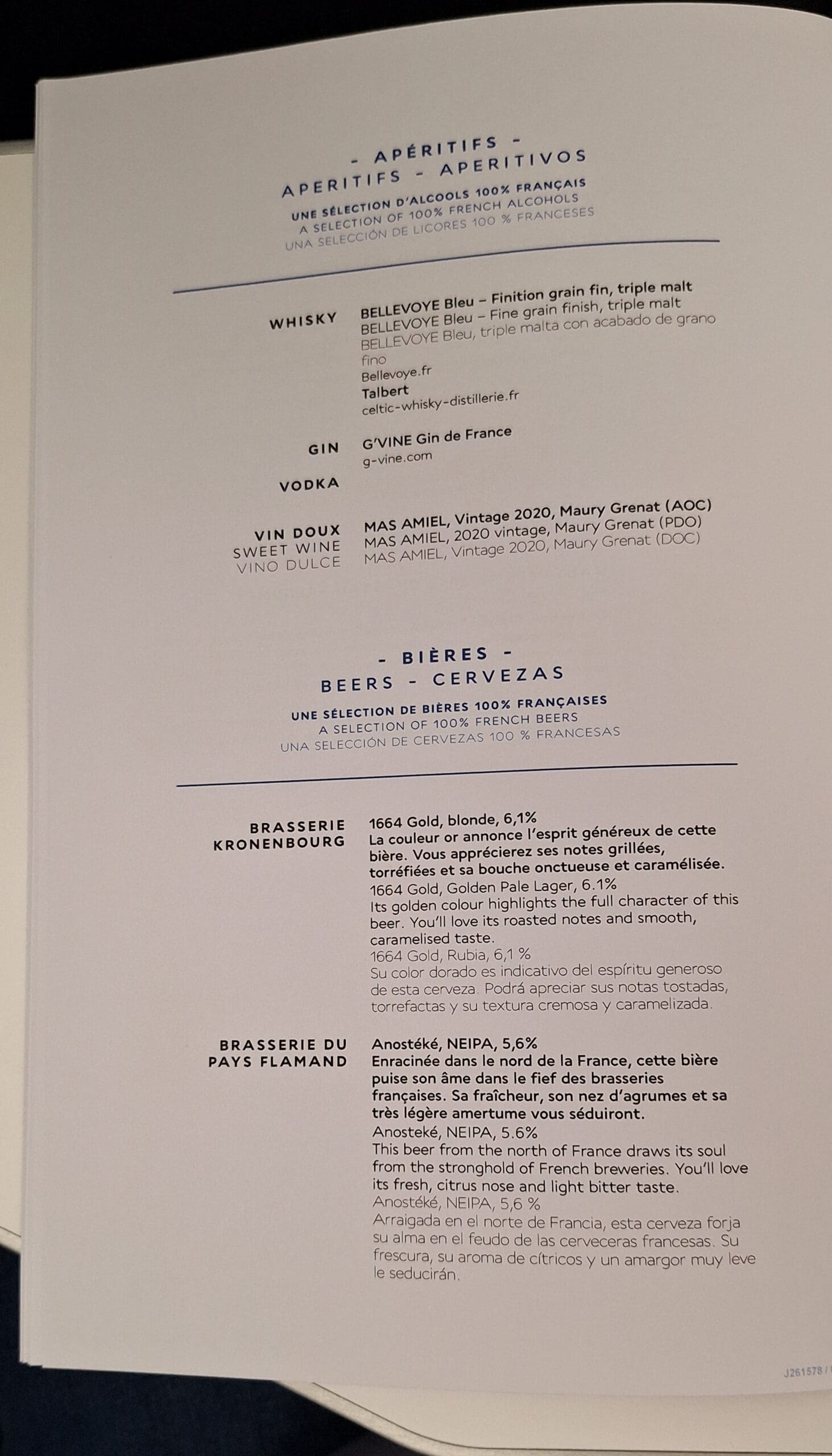 This image shows a menu page featuring a selection of 100% French alcoholic beverages. It includes sections for aperitifs, whiskies, gin, vodka, sweet wine, and beers. Each section lists specific products with descriptions in French, English, and Spanish. The whisky section features "Bellevoye Bleu," the gin section lists "G'Vine Gin de France," and the sweet wine section includes "Mas Amiel, Vintage 2020, Maury Grenat." The beer section highlights "1664 Gold" from Brasserie Kronenbourg and "Anosteké, NEIPA" from Brasserie du Pays Flamand.